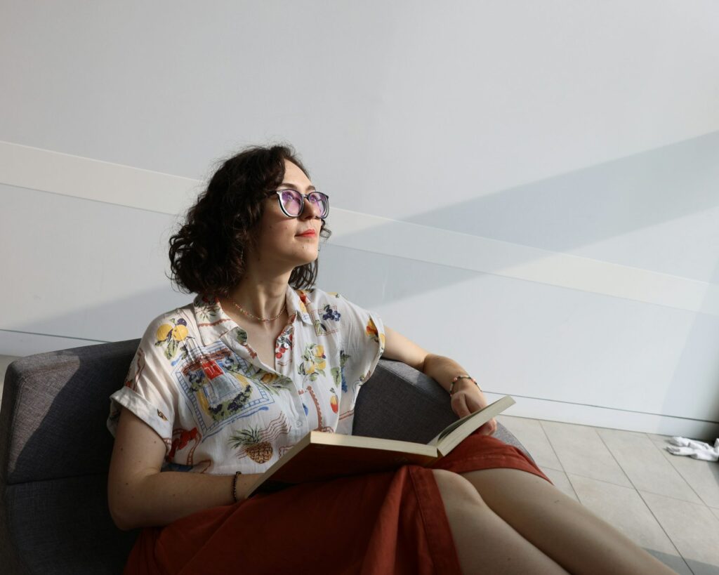 Woman relaxing with a book in a sunlit armchair